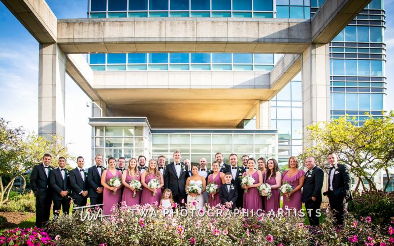 Large wedding party in formal photo.