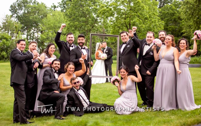 Casual but posed wedding photo of bridal party.