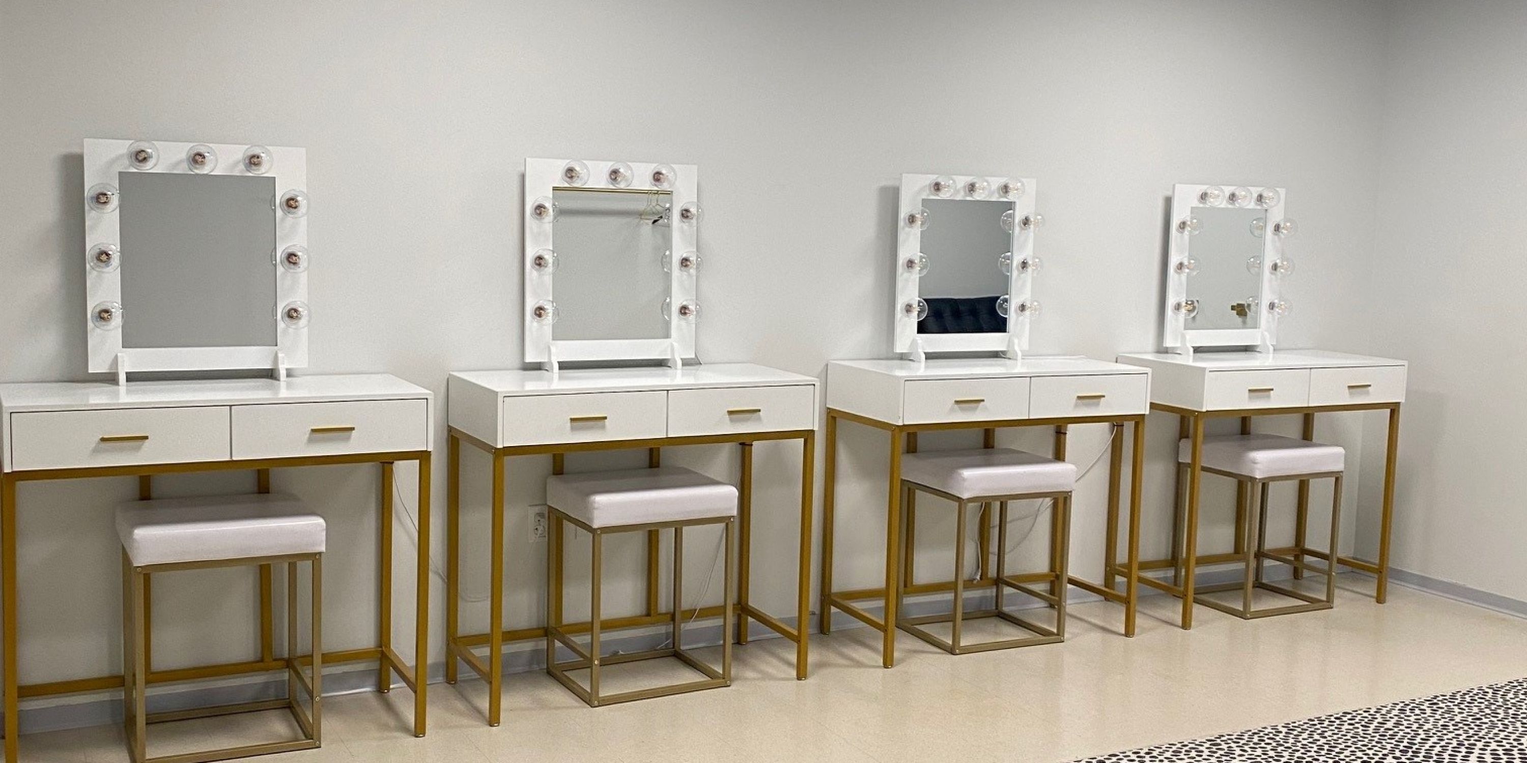 Row of vanity tables with light up mirrors.